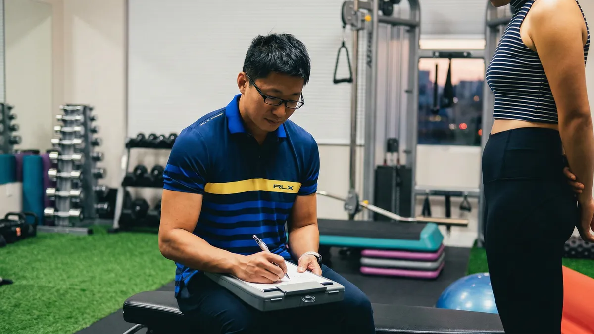 Bo Li coaching and documenting a training session at YouHua Fitness